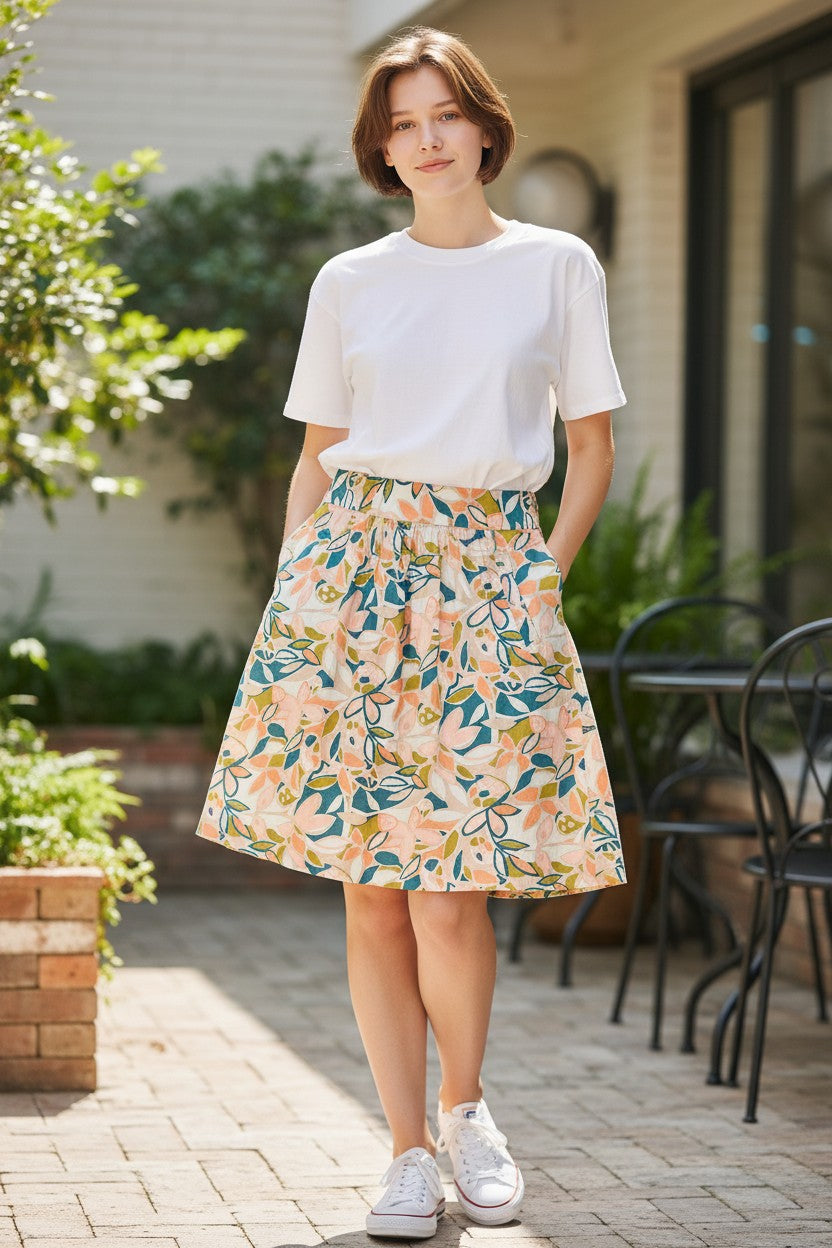 Lady Bear Resale J. Crew floral print lined skirt with pockets, size 12. Features pink, teal, and olive green abstract floral pattern on a white background.