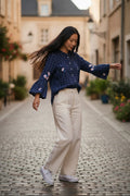 Lady Bear Resale navy blue long sleeve blouse with white polka dots and embroidered flowers on sleeves and chest. Size Large.